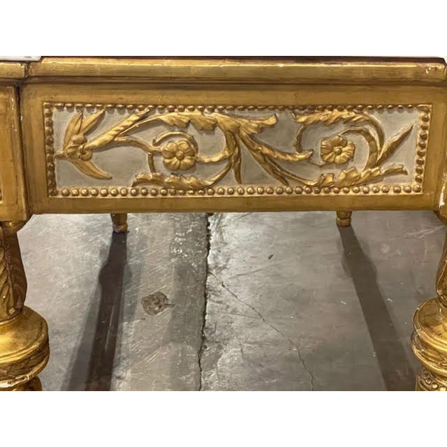 The 18th century Italian Neoclassical Parcel Gilt Console is a luxurious and elegant piece of furniture that exudes...