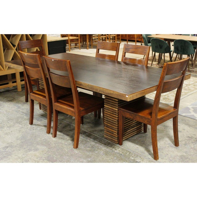 This dining set features a rectangular reclaimed Peroba wood top with a warm, naturally aged finish that highlights its...