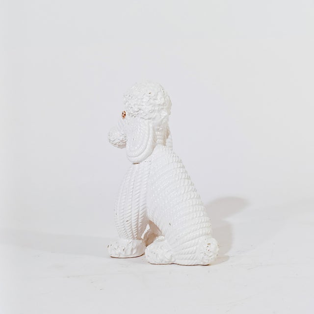 Poodle figure in Italian ceramic from Bassano, 1980s. Body entirely in white glazed ceramic with gold details. Totally...
