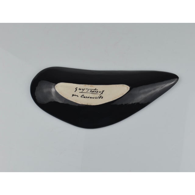 A striking and rare set of three French ceramic pieces featuring marine motifs, designed by Guy Trévoux for the renowned...