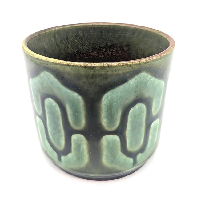 Offered is a circa. 1970s glazed stoneware decorative planter with a geometric pattern in contrasting shades of green made...