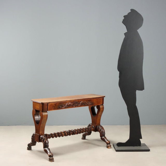 Mid-19th century walnut side table, originally part of a psyche, featuring a drawer with a finely carved front in the...