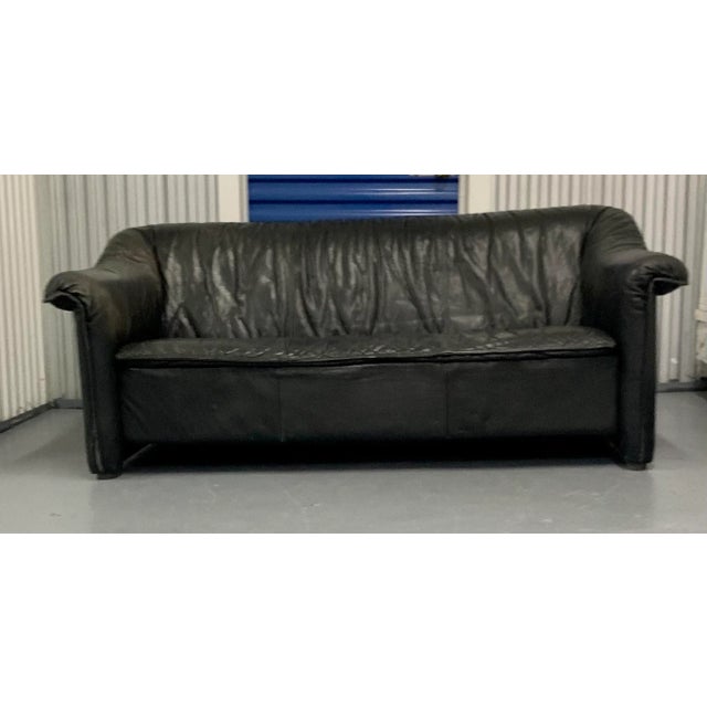 Black buffalo leather, fixed cushion, on short cap feet, labeled Winner Denmark, circa 1980,