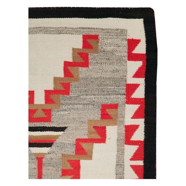 An antique North American Navajo tribal flat-weave throw rug in the rustic southwestern style handmade during the early...