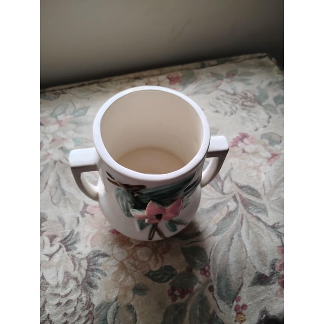 McCoy art Pottery called Blossom Time handled vase. Likely produced in the 40 or the 50. Pictures of makers marks...