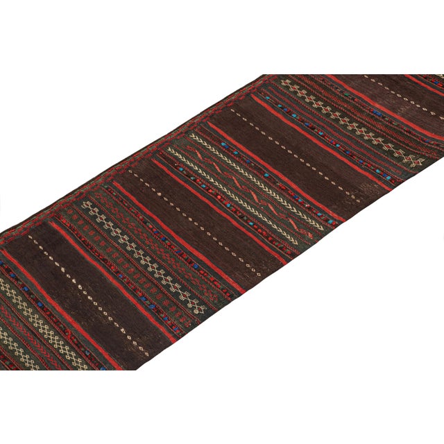 This vintage 2x10 Persian kilim runner is handwoven in wool, and originates circa 1950-1960. On the Design: This design...