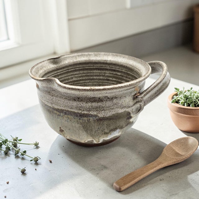 A hand-thrown California studio pottery batter bowl, signed “Margie” and dated 1980, reflecting the regional studio craft...