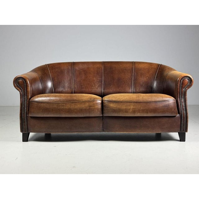 Two-seater sheepskin sofa. from the Dutch brand Joris. In very good condition, with a beautiful color and patina....