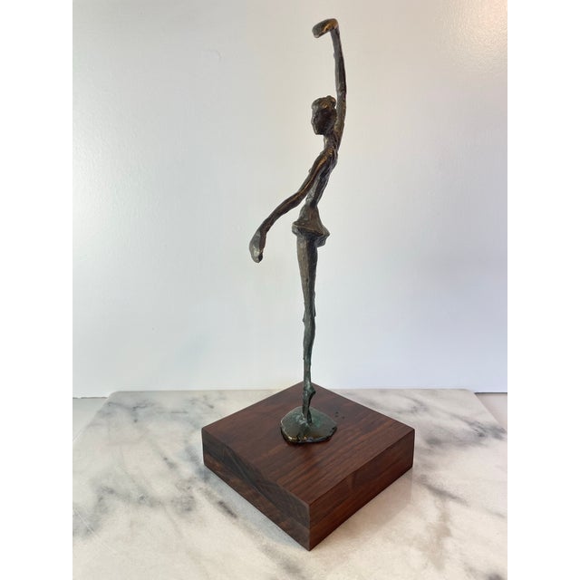 Vintage abstract figurative sculpture depicting a graceful ballerina in motion, cast in bronze (or bronze-toned metal)...
