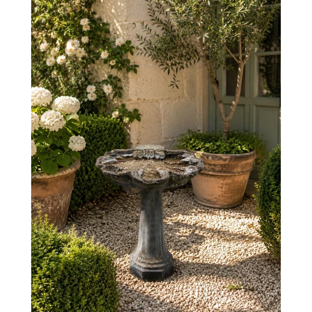 A wonderfully sculptural vintage cast concrete birdbath in the form of a stylized clam shell, raised on a substantial...