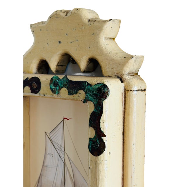 A finely detailed sailboat painting featuring delicate linework throughout the sails, rigging, and hull. Soft blue tones...