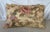 This pair of decorative lumbar pillows features an elegant vintage-style floral design on a warm beige background. The...