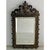 A stunning antique tabletop or wall mirror featuring two mythological dragons holding a coat of arms or family crest with...