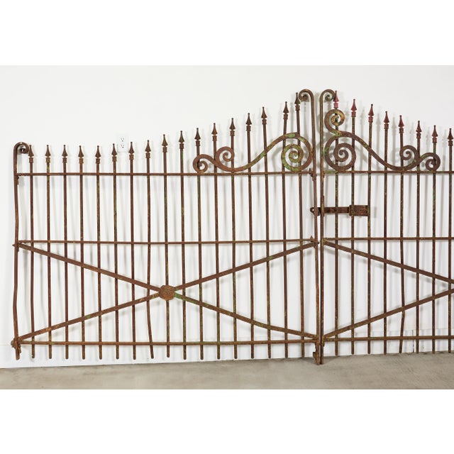 A substantial 19th century double entry gate, constructed of cast and wrought iron and retaining an exceptional weathered...