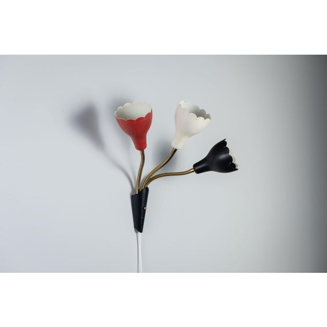 This vintage wall lamp stands out with its playful yet elegant design, combining functionality with a distinctly mid-...