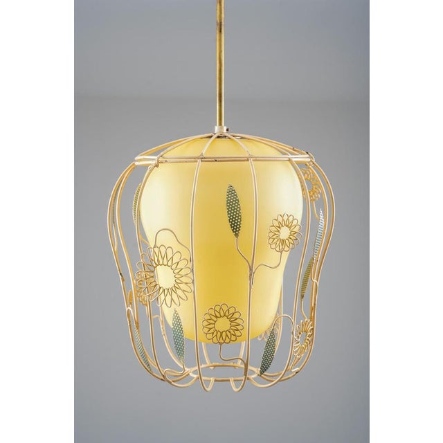 Decorative Swedish Modern pendant designed by Gunnar Eklöf for Corona in the 1940s. The lamp features a softly curved...