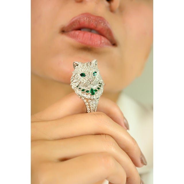 Make a bold and whimsical statement with this exquisitely crafted white gold ring, featuring a detailed cat motif...