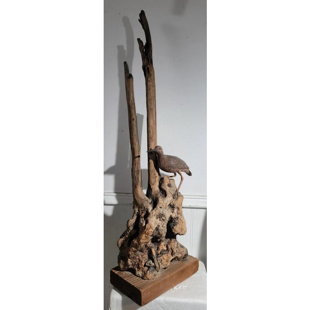 This folk art sculpture of drift wood and a plank wood base is all hand made.The bird is also wood carving added to the...