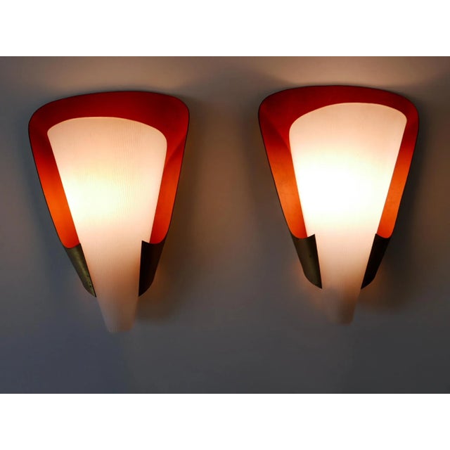 Set of two rare and elegant Mid-Century Modern sconces. Designed & manufactured in Germany, 1960s. Executed in brass and...