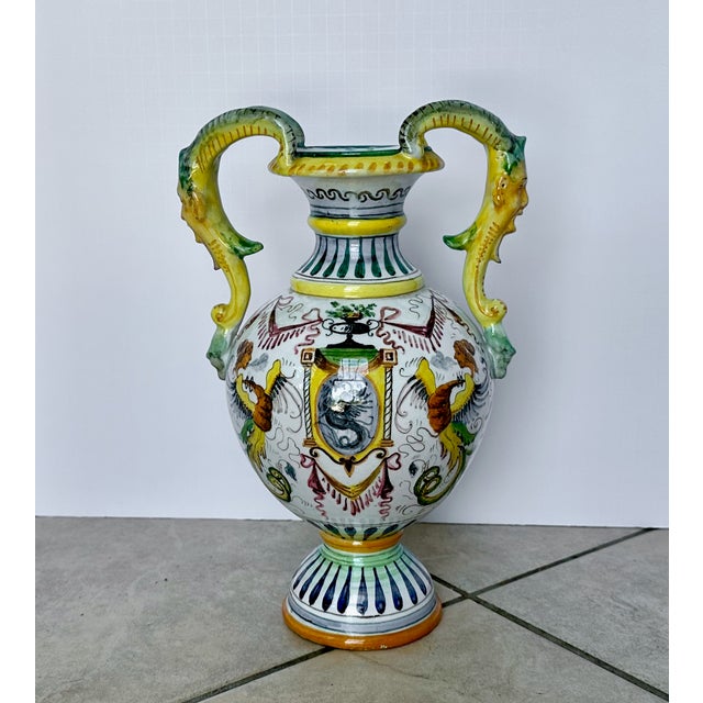 Italian majolica vase with hand painted tin glaze over earthenware ceramic pottery. Handmade with stylized face handles...