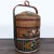 This is an antique Chinese wedding basket. The hand-painted woven reed basket features three tiers with floral decorations...