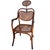 Late Victorian Austrian bent oak and brass barbers chair with a cane seat and backrest featuring an elegant, sculptural...