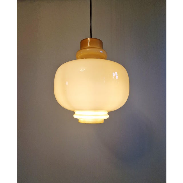 Scandinavian pendant light in mustard opaline glass. model: oplight 75 designer: hans-agne jakobsson manufacturer: staff...