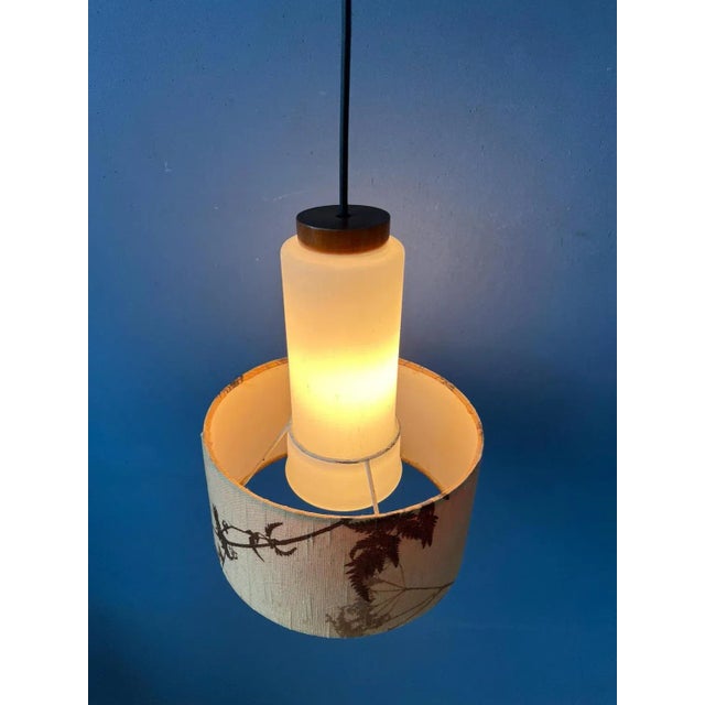 Danish opaline glass pendant light with textile jungle patterned shade. The glow emitted from the milk glass nicely...