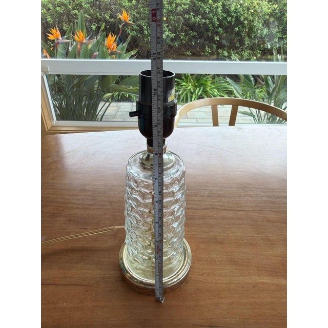 Vintage Mid-Century Modern table lamp featuring a textured clear glass body with a geometric hexagon pattern. The lamp...