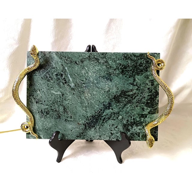 This signed archival Michael Aram green marble brass snake tray functions as a high-end statement piece for upscale...
