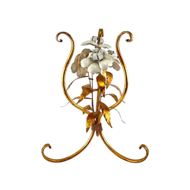 A gorgeous, vintage tole table. Features an iron frame finished with hand applied gilding and adorned with white enameled...