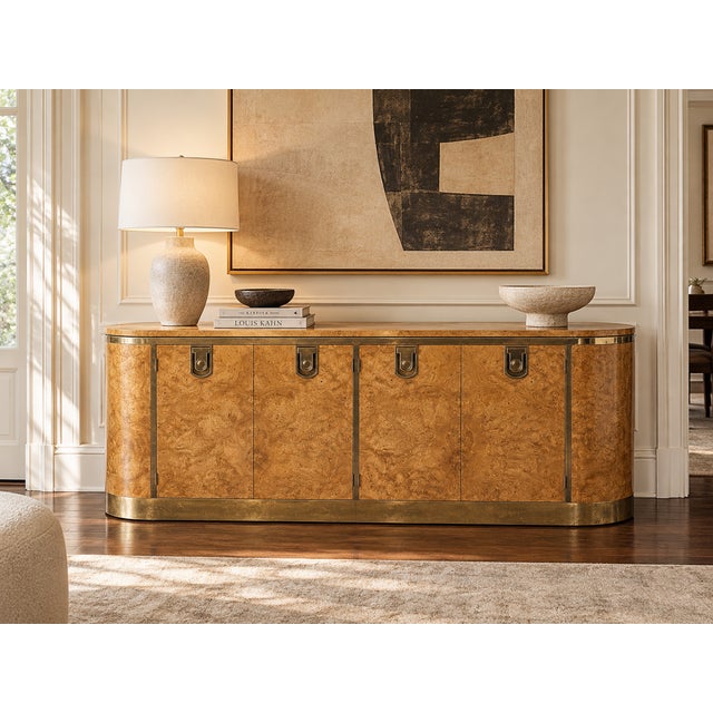 An exceptional 1970s Hollywood Regency credenza attributed to Mastercraft, distinguished by its sculptural racetrack...
