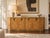 An exceptional 1970s Hollywood Regency credenza attributed to Mastercraft, distinguished by its sculptural racetrack...