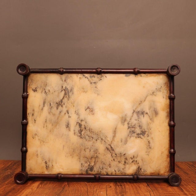 This elegant rectangular serving or tea tray features a striking juxtaposition of materials. The center is inset with a...