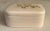 Add a little glamour to your decor with this ivory porcelain cigarette or jewelry box with gold detailing. Part of the...