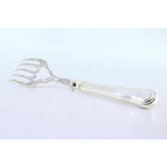Silver Fish Serving Fork with Reliefs and Crown, in Very Good conditions. Designed before 1890 This piece has an...