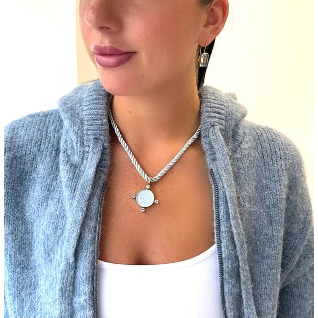 A favorite...Nike riding horses with Blue Topaz accents. Paired with a silvery pale blue rope to complete the look. 18"