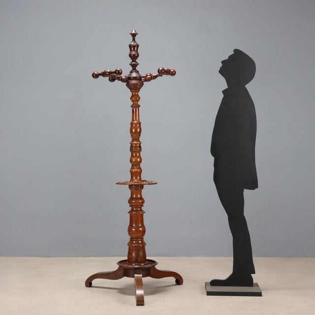 Walnut coat stand with umbrella stand and walking stick holder. Italy, late 19th century. This piece is attributed to the...
