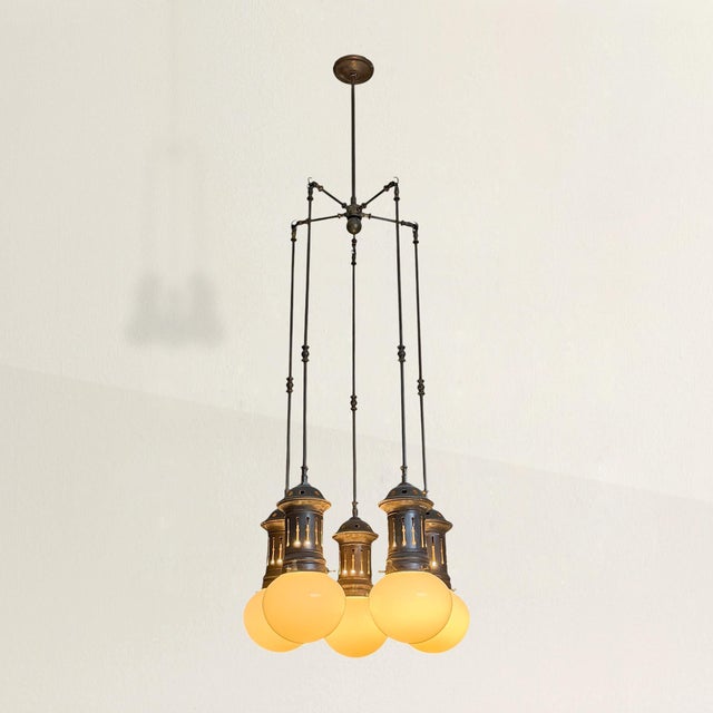 It’s the kind of fixture that makes you look twice. At the center, a compact hub sends out five short arms, each ending in...