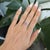 A natural pink sapphire glows softly within a halo of brilliant diamonds in this pear-shaped ring, crafted in solid 14K...