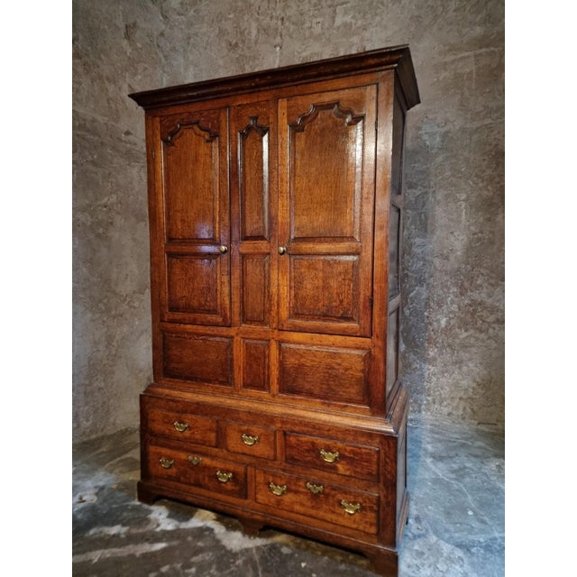 This antique English oak cabinet originates from England and dates from the late Georgian period, circa 1800–1820. Crafted...