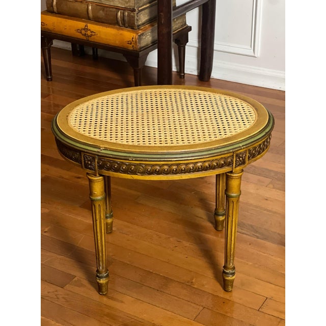 An early 20th century French Louis XVI style walnut oval tabouret stool or side table fitted with a woven cane top. Finely...