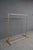 Industrial-style freestanding garment rack constructed from copper plumbing pipe with a warm natural patina. Featuring a...