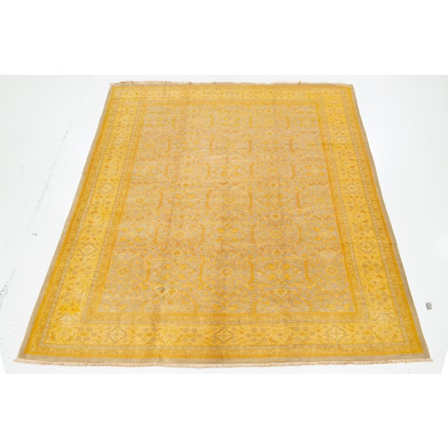 This antique Persian wool rug features a gray field with yellow accents and an all-over floral pattern. This rug measures...