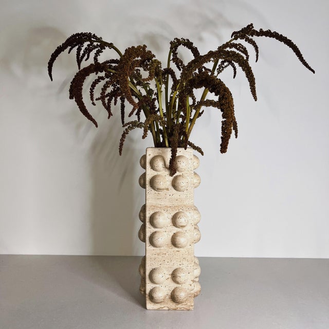 Handcrafted from white travertine, the Bubble Vase pairs a clean architectural silhouette with playful spherical detailing...