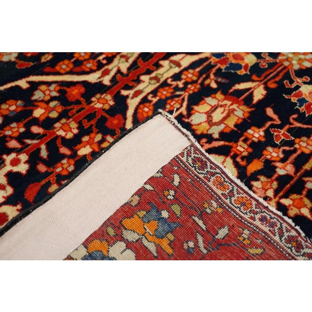 This c. 1900 finely woven scatter from a village context in western Persia features a deep indigo navy ground with a...