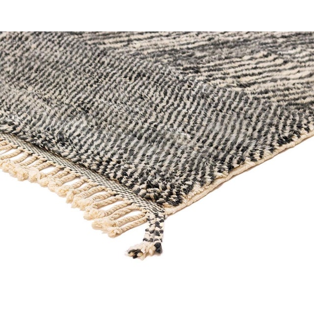 Contemporary hand-knotted wool rug featuring a bold chevron pattern in Charcoal, Midnight Black, and Ivory, creating a...