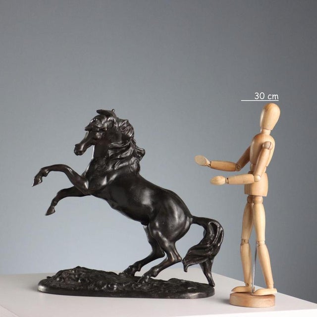 Bronze sculpture depicting a rearing horse. The artist's signature is unreadable on the base. This piece is attributed to...