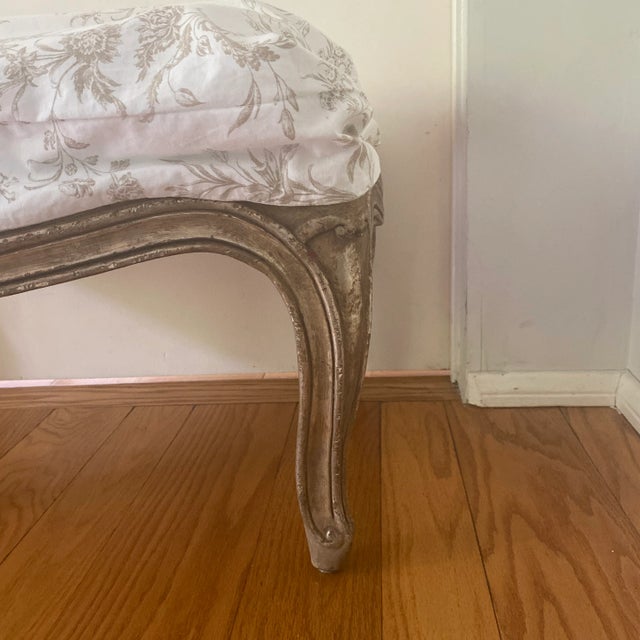 This is an ottoman with a genuine silver leaf distressed finish. The silver is burnished and purposely aged for a soft...