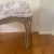 This is an ottoman with a genuine silver leaf distressed finish. The silver is burnished and purposely aged for a soft...